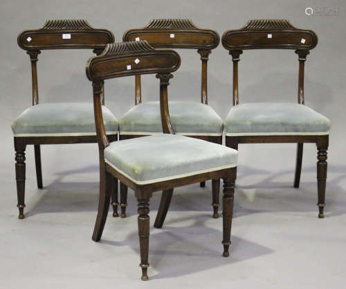 A set of four William IV mahogany bar back dining chairs with reeded decoration and foliate mouldings