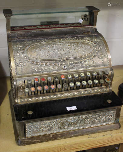 A late 19th century brass cased National counter-top cash register with overall cast foliate scrolls