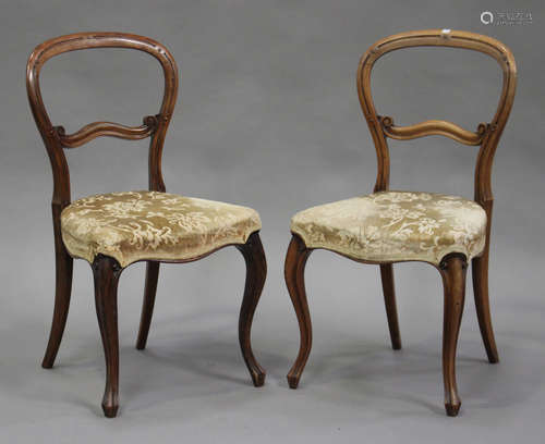 A set of six Victorian walnut balloon back dining chairs