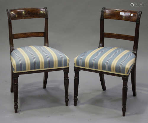 A pair of late George III mahogany bar back dining chairs with carved and inlaid decoration