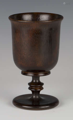 A mid-19th century turned treen goblet with an overall rich dark brown patina