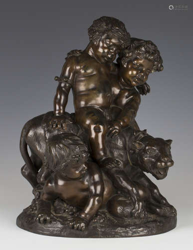 A mid/late 19th century French brown patinated cast bronze figure group of two fauns and a putto astride a wild cat