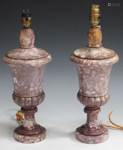 A pair of late 19th/early 20th century purple stained alabaster table lamps of urn form