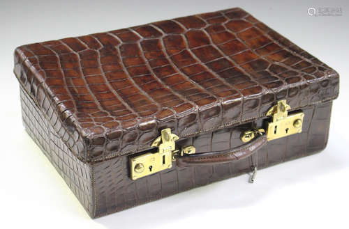 An early 20th century crocodile skin case