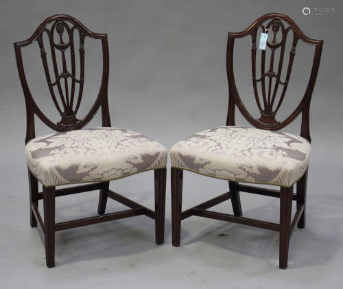 A pair of 19th century Sheraton style mahogany shield back dining chairs with carved decoration