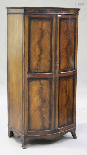 An early 20th century mahogany bowfront wardrobe