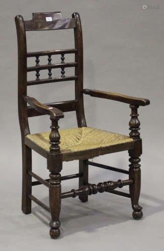 A 19th century stained ash bar and spindle back armchair with a rush seat