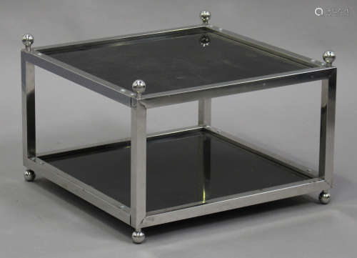 A 20th century chromium plated two-tier table with inset black glass panels