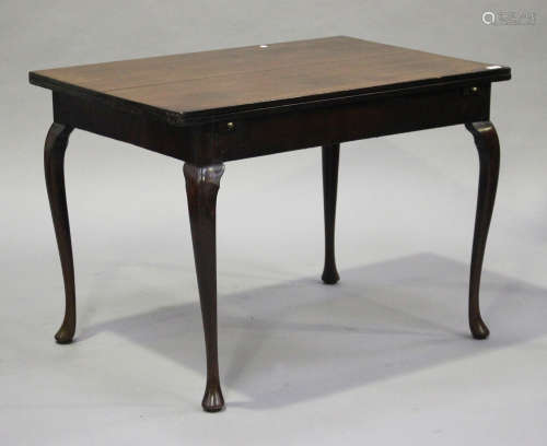 A George III and later mahogany fold-over dining table