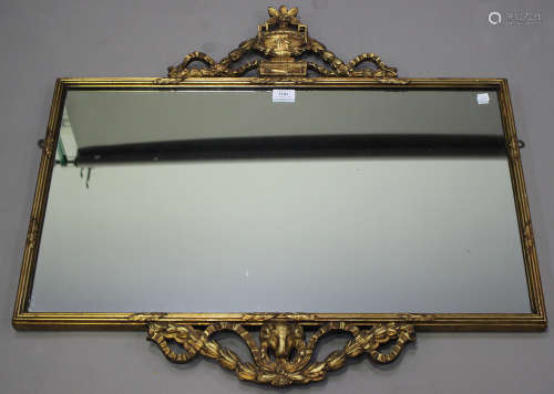 An early 20th century Adam style giltwood wall mirror with urn surmount and ram swag apron