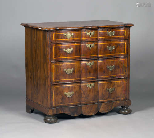 An 18th century Dutch yew serpentine fronted commode
