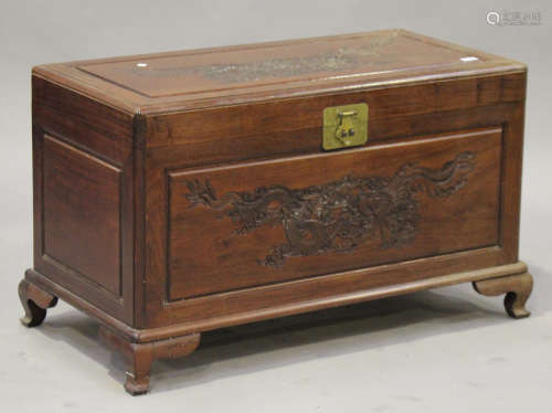 An early 20th century Chinese camphor trunk with carved decoration and hinged lid