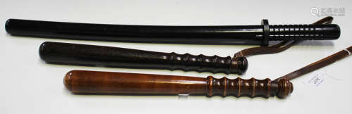 Two early 20th century turned hardwood truncheons with leather strap handles