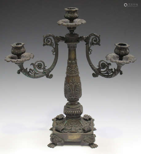 A Regency brown patinated cast bronze three light candelabrum