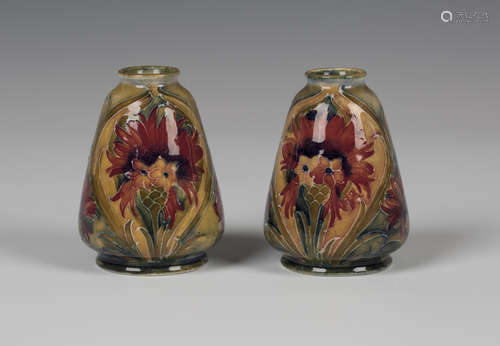 A pair of Moorcroft pottery miniature vases