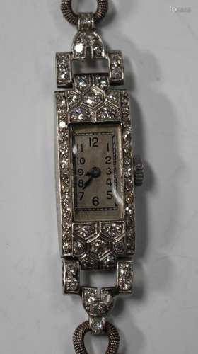 A platinum and diamond rectangular cased lady's dress wristwatch