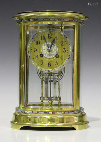 An early 20th century French brass and champlevé enamel four glass mantel clock with eight day movement striking on a gong