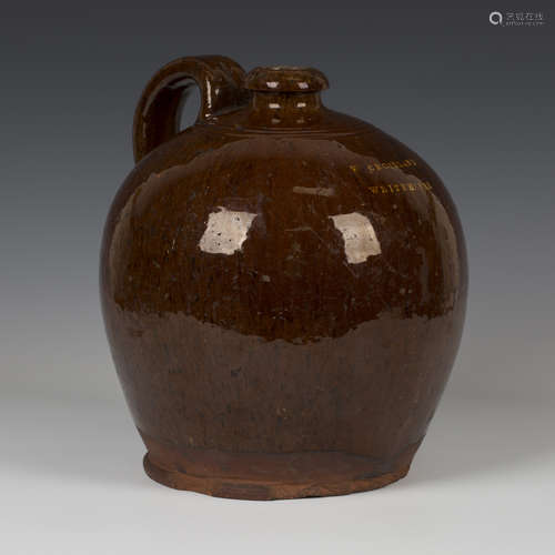 A Sussex pottery brown slip glazed flagon