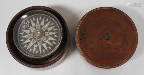 A brass cylindrical compass