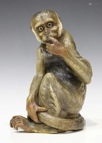 A Continental terracotta model of a seated monkey