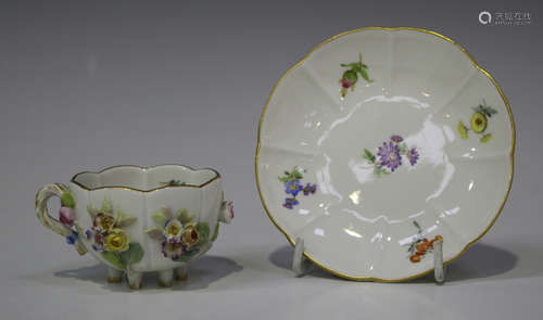 A Meissen porcelain floral encrusted cabinet cup and saucer