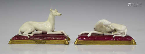 A pair of English porcelain recumbent greyhounds