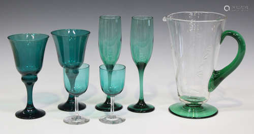 A collection of mostly green tinted glassware