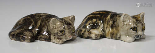 A near pair of Winstanley pottery reclining cats