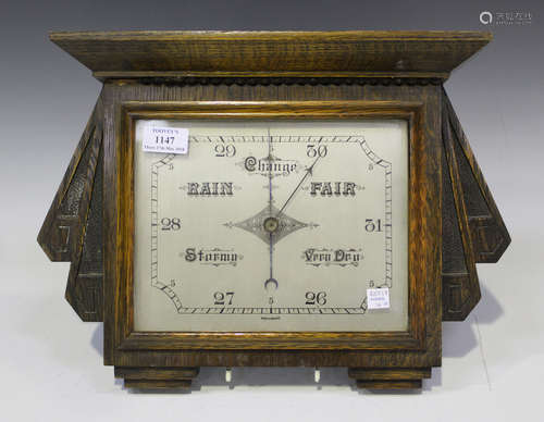 An Art Deco oak cased wall barometer with silvered dial