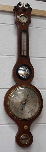 An early 19th century mahogany wheel barometer with silvered dials