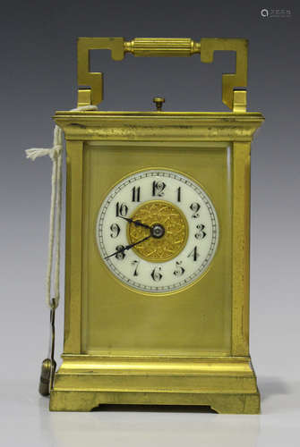 An early 20th century French lacquered brass carriage clock with eight day movement striking and repeating on a gong