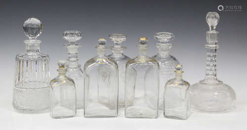 A group of glass decanters and stoppers