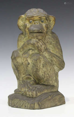 A Continental pottery slipcast model of a seated monkey