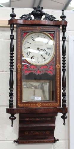 A late 19th century inlaid mahogany wall clock with bell strike movement