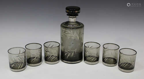 An engraved glass decanter and six matching tumblers