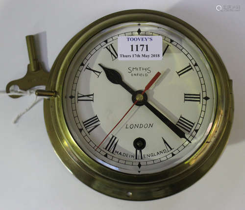 An early 20th century brass cased circular ship's timepiece