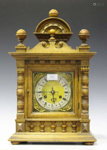 A late 19th century walnut mantel clock with eight day movement striking on two gongs