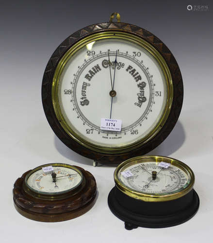 An Edwardian oak cased circular wall barometer with opaline glass dial