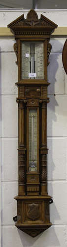 A late Victorian oak stick barometer with mercury thermometer