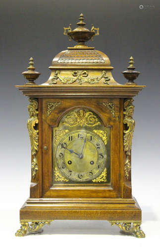 A late 19th century German gilt brass mounted walnut mantel clock with eight day movement striking on two gongs