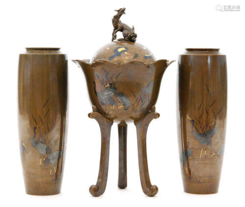 A Meiji period Japanese mixed metal garniture composed of two vases and a koro