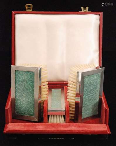 A cased hallmarked set of three silver and shagreen backed brushes London 1947 and 1950