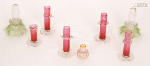 A group 19th Century and later glass comprising a set of five table centre spill vases with glass chain and metal fittings with clear crystal flower form feet below ruby sleeve form stems