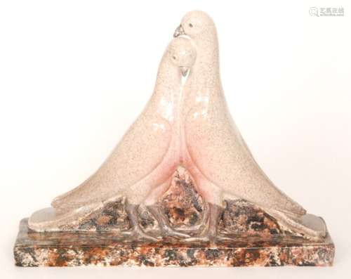 A studio pottery model of two doves stood on a rectangular plinth