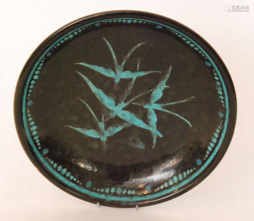 A 1930s French Art Deco shallow bowl slip decorated with four swallows to the centre in blue against a black ground with a matching turquoise border