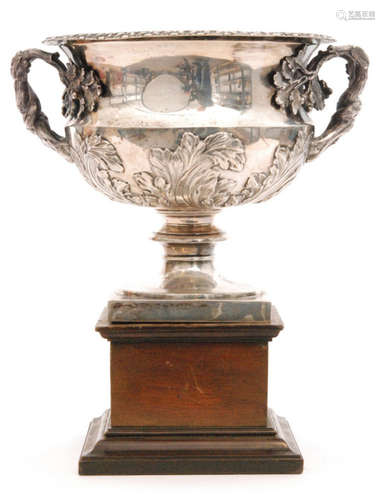 A hallmarked silver twin handled bowl in the manner of a Warwick vase with embossed oak leaf details and twisted bark handles