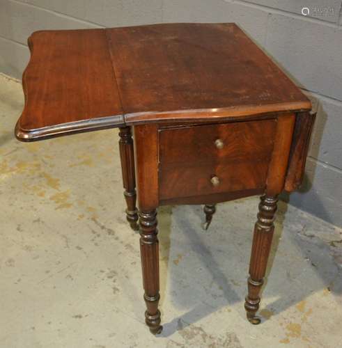 A 19th Century mahogany drop flap work table with butterfly shaped top on reeded legs and castors