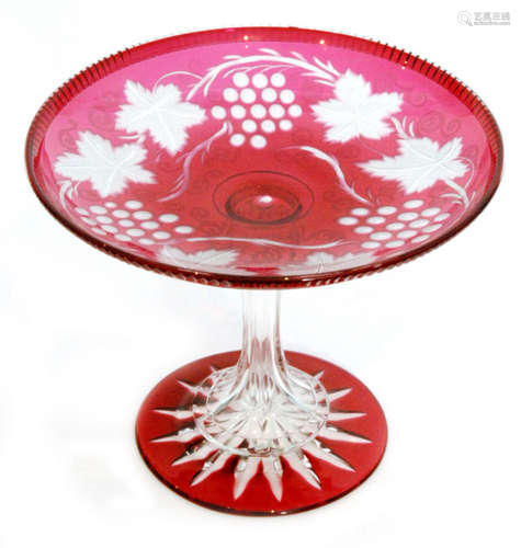 A late 19th Century Stourbridge ruby cased footed tazza having a circular star cut foot rising to a facet cut hollow stem set with a shallow dish plate