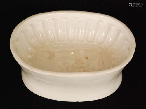 A 19th Century jelly mould with a cow creamer and milk maid to the centre