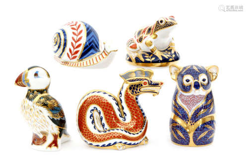 Five assorted Royal Crown Derby paperweights comprising a dragon